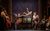 Calamity Jane Carrie Hope Fletcher as Calamity Jane lying on top of a piano singing. The cast around are in costumes and playing instruments.