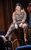 Calamity Jane Carrie Hope Fletcher as Calamity Jane in a wild west costume and sitting on a piano.