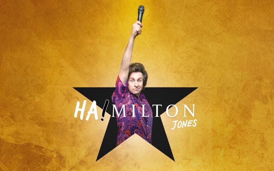 Promotional image in the style of the musical Hamilton's treatment. Milton Jones wearing a floral purple shirt in the middle of a black star holding up a microphone.