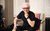 Trevor Horn Trevor Horn in a black T-shirt sat on a rainbow-patterned chair, smiling at the camera and resting his chin on his hand.
