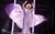 Kinky Boots Johannes Radebe as Lola singing into a microphone wearing a long sparkly lilac dress billowing around them.