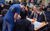 Workshop in Learning Suite. Credit Ant Robling Ashley from the Learning and Engagement team leans down and talks to a group of secondary school students sitting around a desk during a careers workshop