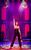 Nic Myers (Kathryn) in Cruel Intentions: The '90s Musical. Credit: Pamela Raith Nic Myers as Kathryn stood alone on stage in a black and orange leather corset with her right hand pointed straight in the air.
