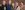 The company of By Royal Appointment with their arms around each other and smiling at the camera.