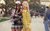 Clueless Iconic still from Clueless of Cher and Dionne in their plaid outfits standing back-to-back.