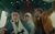 The Phoenician Scheme Three people in a small plane cockpit. The pilot is in a pinstriped suit with a sling round his arm and a controller microphone. Behind him in a woman in a religious nurse's outfit and another man in a brown suit with bow tie and waistcoat.