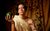 Chloe Petts Chloe Petts in a toga sat in front of a table of fruit holding a watermelon.