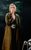 The Girl On The Train Laura Whitmore as Rachel in a long brown trench coat. By her side is a carry cot.