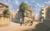 The Girl Who Leapt Through Time Street junction with two building-lined streets in view and three illustrated figures, one of which is on a bike.