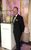 Matt Collier Matt stood in a suit next to a cabinet displaying Fabergé