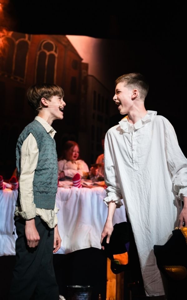 Charlie and Grandpa Joe sing towards each other with the Buckets in the background