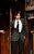 Dylan Dylan entering a doorway wearing a suit and talking.