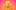 Paulus the Cabaret Geek stands in a bright orange raincoat and yellow hat with a larger-than-life grin, wide-eyed and open-mouthed. The background is a soft pink and orange hue.