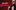 Tom Davis smoulders at the camera and tugs on the collar of his Adidas track jacket against a deep red background. Bold text reads Tom Davis Spudgun.
