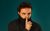 Vittorio Angelone Vittorio Angelone with a turtle neck pulled up his mouth and his finger over where is mouth would be in a 'be quiet' gesture.