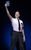 The Book of Mormon Elder Price dressed in Mormon uniform holding the book in the air in The Book of Mormon.