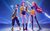 KPop Demon Hunters Three animated K-pop stars stand in fierce poses with glowing fantasy weapons against a starry background.