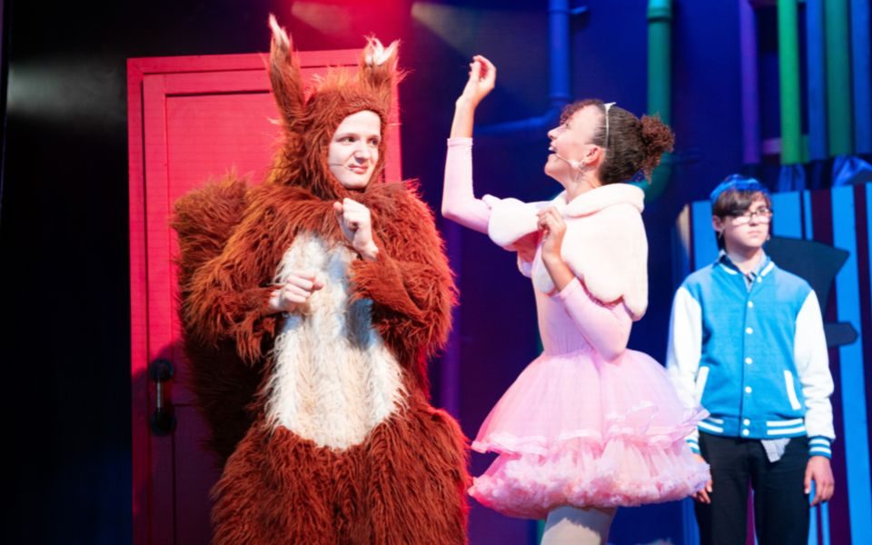 Veruca Salt and Jeremy. Credit Chris Coote An actor in a squirrel costume is prodded at by Veruca Salt in her pink tutu and ballet clothes