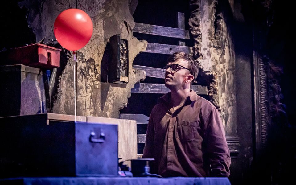 Herbert looks up at an ominous red balloon