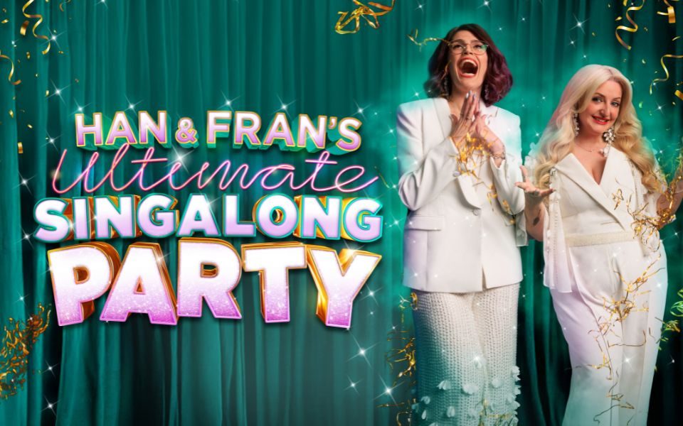 Han and Fran smile and laugh below sparkling ribbons of gold confetti, in front of a turquoise curtain. Pink text reads: Han and Fran's Ultimate Singalong Party.