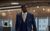 Highest 2 Lowest Denzel Washington walking dramatically in a blue suit