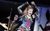 Kerry Ellis in We Will Rock You Kerry Ellis dressed at Meat in We Will Rock You. She wears a punky costume with red and black short shorts, belts, a purple and green corset, and fishnet sleeves.