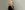 Kerry Ellis wearing a back top looking over her right shoulder.