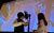 LHT Unwrapped: Halloween SFX Workshop Two young people at a microphone doing foley work as Corpse Bride plays on a screen behind them