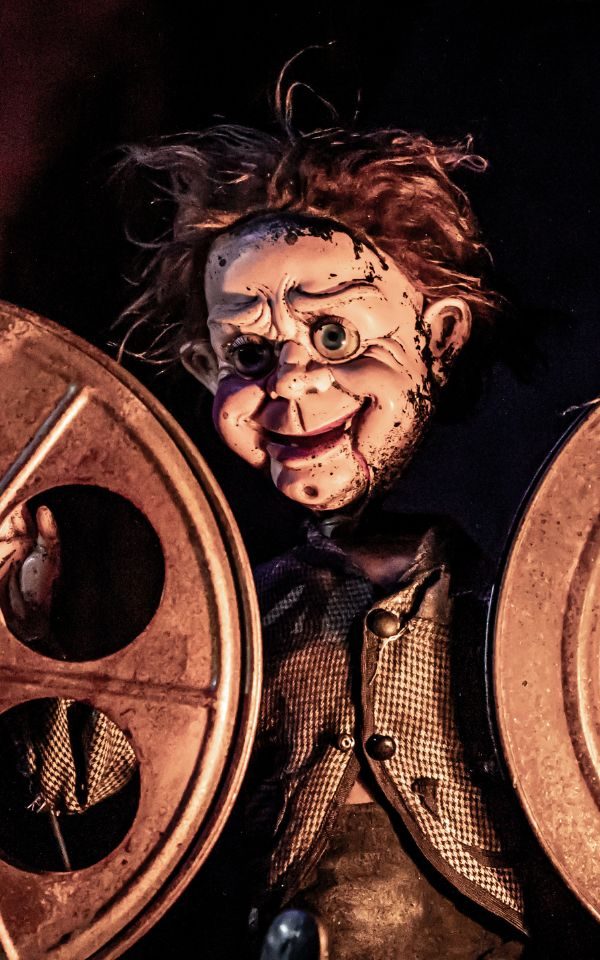 A creepy puppet between two old film reels