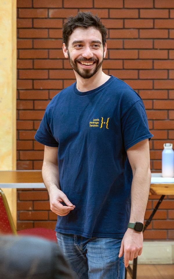 Ashley smiling in a Leeds Heritage Theatres t-shirt.