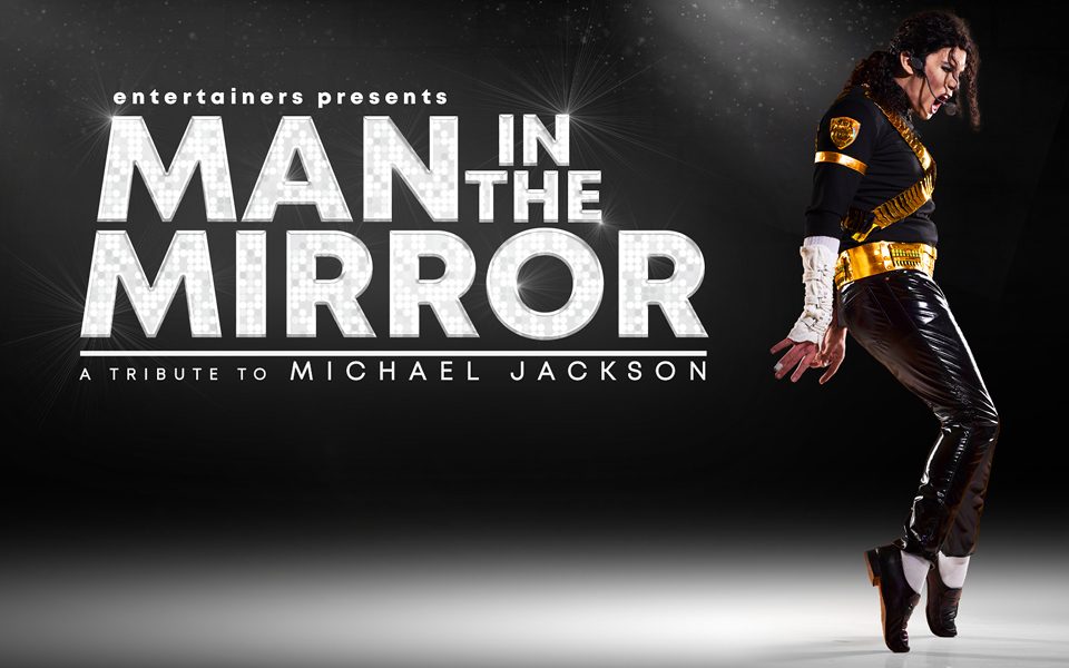 A Michael Jackson tribute act wearing a black and gold-detailed top, white wrist warmers and black latex trousers. He has a headset microphone and is up on his tip-toes with a light shining on him. Text reads: Entertainers presents Man in the Mirror. A Tribute to Michael Jackson