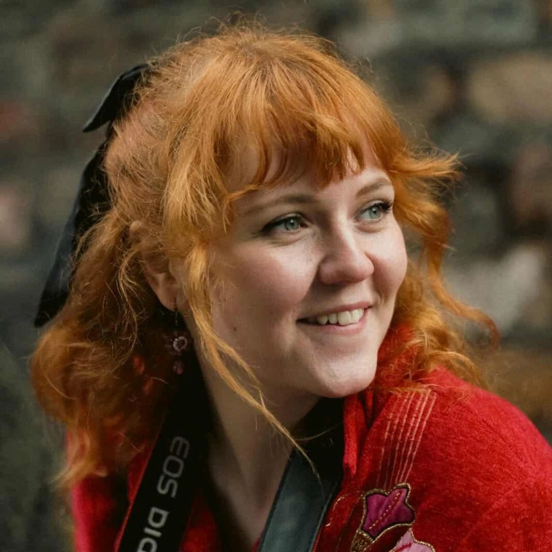 Megan Dobbyn smiles as she look over her shoulder in natural light