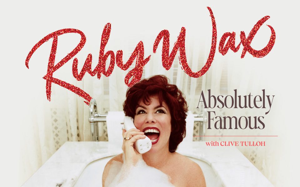 Ruby Wax smiles widely and speaks into a wireless telephone in a bubbly white bath tub, wearing striking red lipstick and make-up. Glittery red text reads: Ruby Wax: Absolutely Famous. With Clive Tulloh.