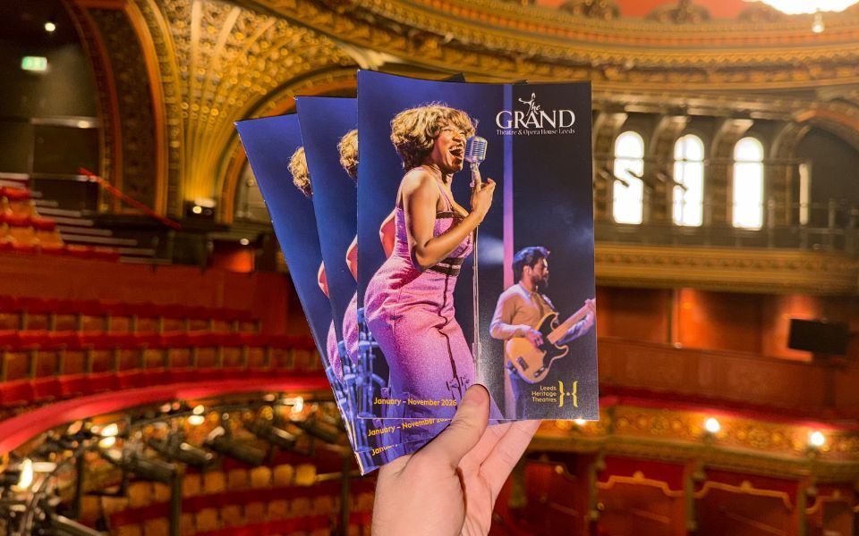 A set of brochures for Leeds Grand Theatre with an image of TINA. The background is the auditorium of the theatre.