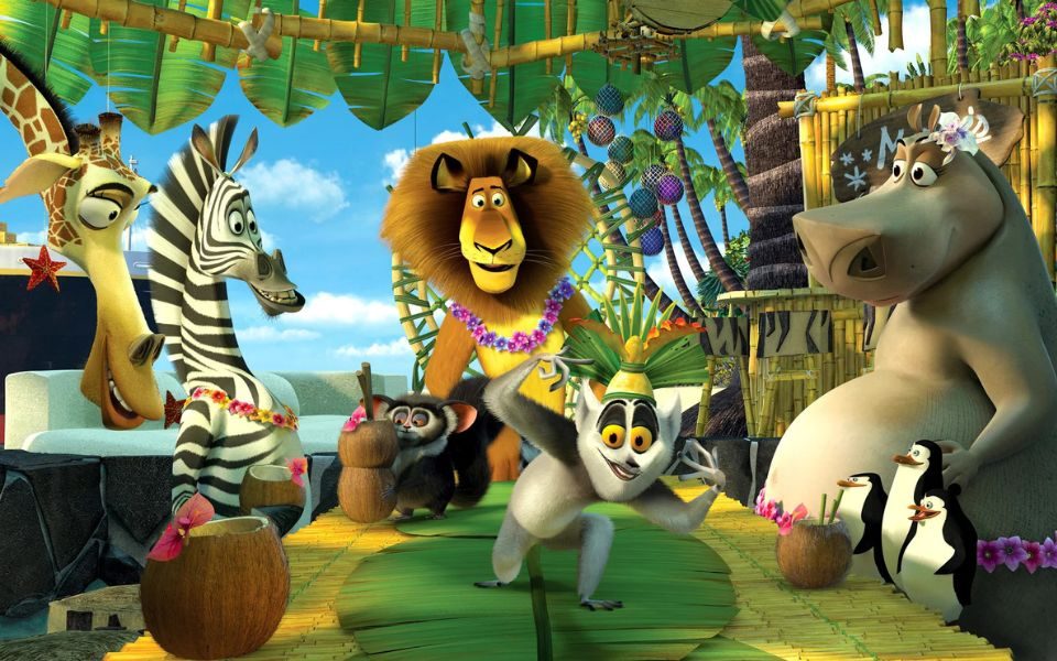 Animated still of animal characters, including a giraffe, zebra, lion, chinchill and lemur, in floral luaus and drinking from coconuts in a tropical scene.