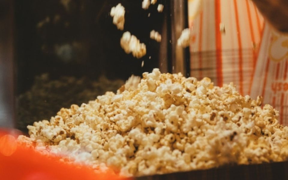 A close-up of popcorn, with some falling at the top of the frame.