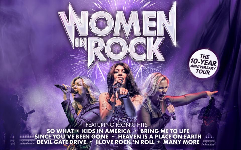 Three women sing into handheld microphones, surrounded by purple haze and fireworks. Metallic text reads: Women in Rock. The 10-year Anniversary Tour. Featuring iconic hits So What, Kids in America, Bring Me to Life, Since You've Been Gone, Heaven is a Place on Earth, Devil Gate Drive, I Love Rock 'n' Roll, and many more.