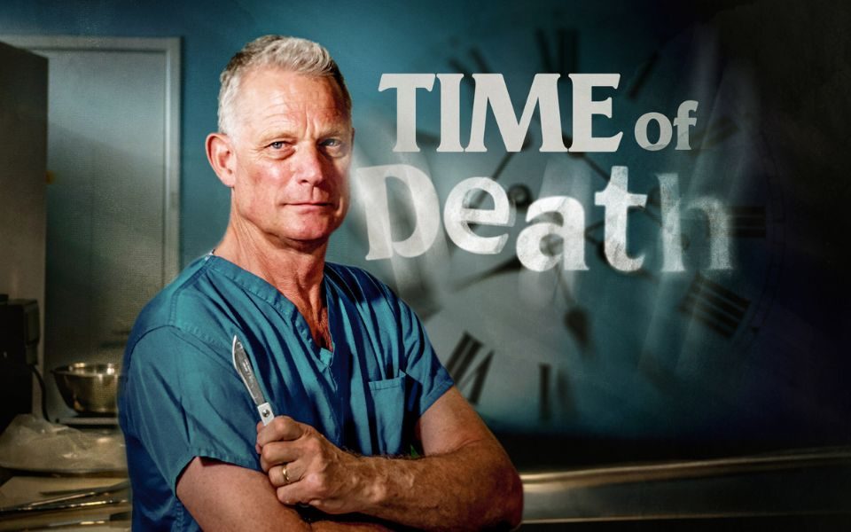 Dr Richard Shepherd stands with arms crossed, holding a scalpel and wearing blue scrubs in a clinical setting. A shadowy clock is visible in the background, obscured by text reading; Time of Death.