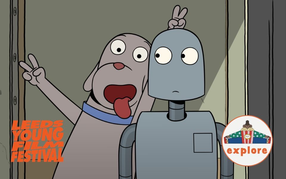 A cartoon dog smiles and sticks out its tongue, holding two fingers behind the head of a robot. In the bottom left, an orange logo reading 'Leeds Young Film Festival'. In the bottom right corner, a roundel featuring a playful illustration of a person sat peering over a bucket of popcorn, on the word 'explore'.