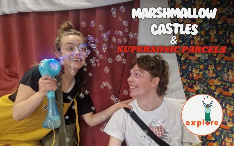 In front of sheets and blankets, two adults candidly smile and play with a bubble machine. Text reads: Marshmallow Castles and Supersonic Parcels. In the bottom right corner, a roundel featuring a playful illustration of a person juggling stood on the word 'explore'.