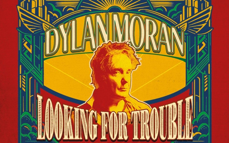 Colourful, illustration style image of Dylan Moran in red and yellow, surrounded by art deco arches and line patterns. Text reads: Dylan Moran: Looking for Trouble. Live Tour 2026-2027.