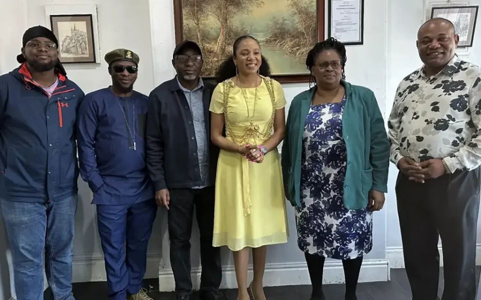 A group of people stood posing in a gallery.