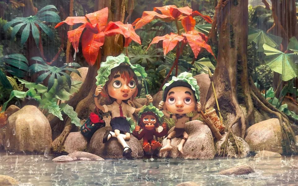Animated still of two children and a small monkey holding large leaves over their head, as rain pours down on them at a river bank.