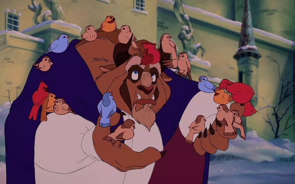Animated still. A big, hairy beast in a purple cloak stands in front of a castle's walls, with a group of birds perched on his back.