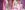 Amber Davies as Elle Woods with long blonde hair and a pink sweatshirt that says 'Harvard'. She sits on a bed in a pink bedroom, surrounded by racks of pink clothes.