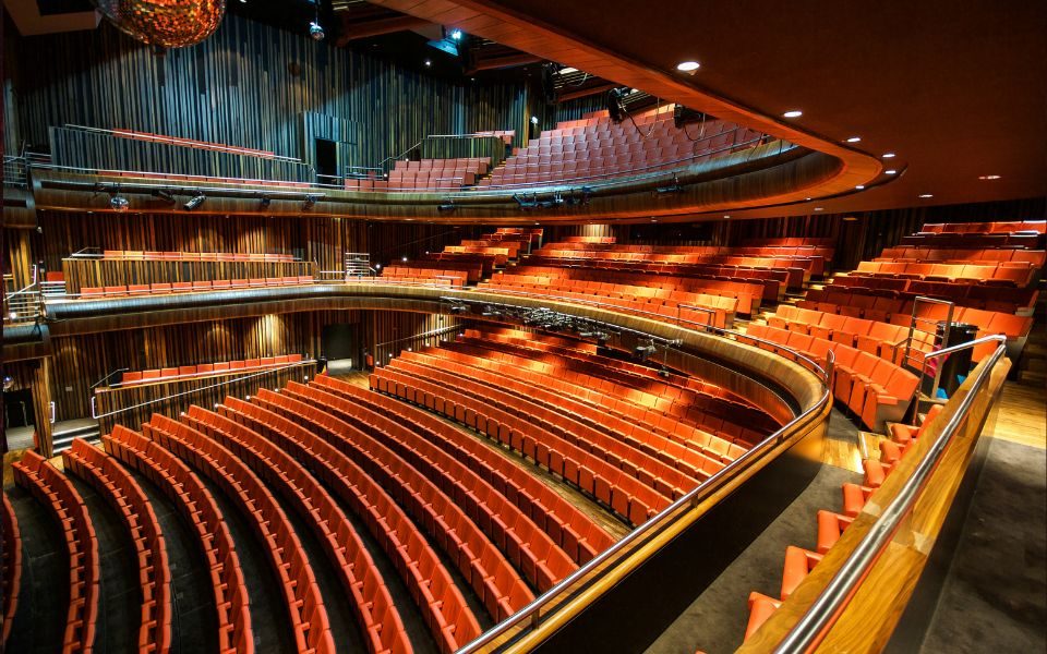 The auditorium at The Marlowe Theatre, Canterbury, featuring red seats.