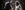 Two actors playing Johnny Cash and June Carter stand either side of a microphone, singing together.
