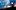 Illustrated image of the silhouette of a 'Cloudbuster' machine which sits atop a hill surrounded by blue and orange clouds. Text reads: Cloudbusting. The Music of Kate Bush. 5 stars. 'Utterly, surreally brilliant'. Mick Wall, Classic Rock Magazine. 5 stars. 'That gave me a shiver'. Jeremy Vine BBC Radio 2. 5 stars. 'Blown away - your spin on Kate Bush is amazing'. RTE Radio. 5 stars. 'I could have been listening to Kate herself!' Preston Heyman.