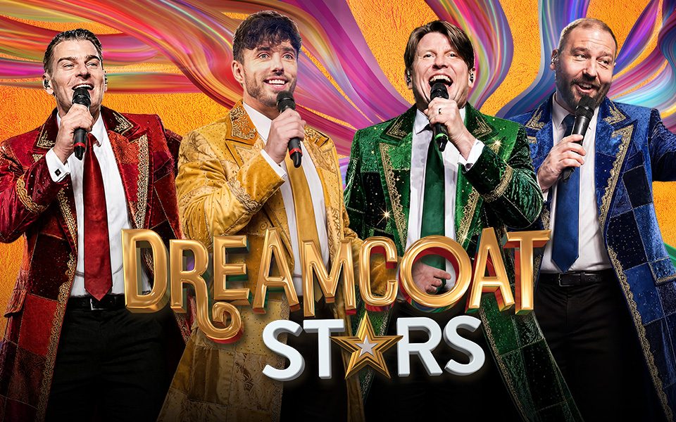 Four men in vibrant multicoloured gowns with gold trim are singing into microphones, in front of a swirling colourful backdrop. Text reads: Dreamcoat Stars.