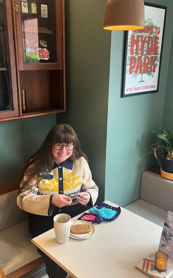 Martha smiling as she crochets in the cafe at Hyde Park Picture House